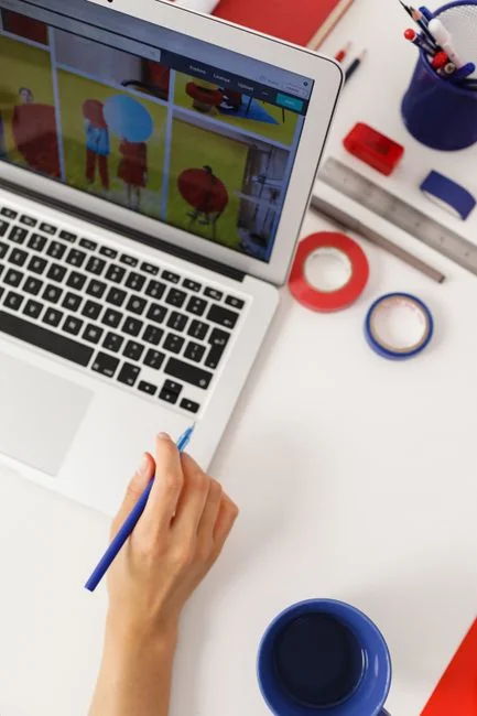 A stylish workspace featuring a laptop and monitors displaying design software.